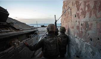 Israeli soldiers take position, amid the ongoing ground operation of the Israeli army against Palestinian Islamist group Hamas, in the Gaza Strip as seen in a handout picture released by the Israel Defense Forces on 13 November, 2023. Reuters